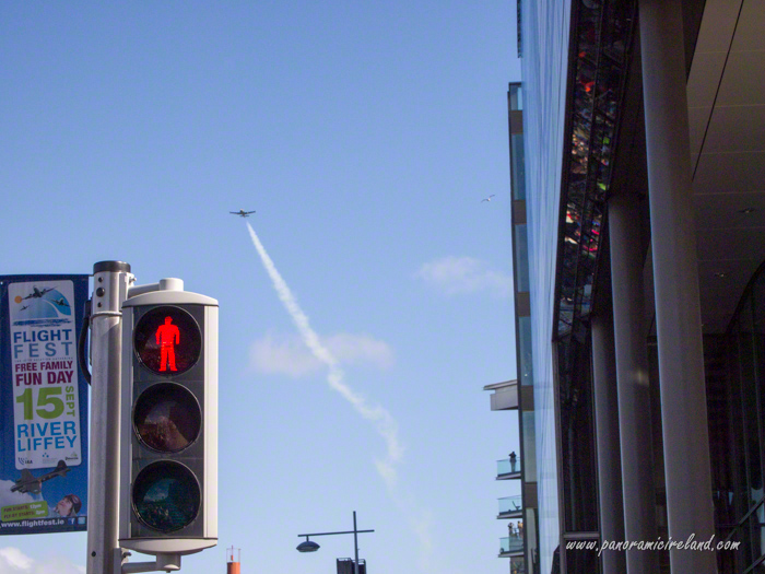 Red man traffic light and Flightfest sign with plane in sky
