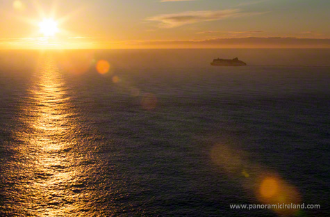 Ferry sailing towards Holyhead and rising sun from Dublin, Ireland