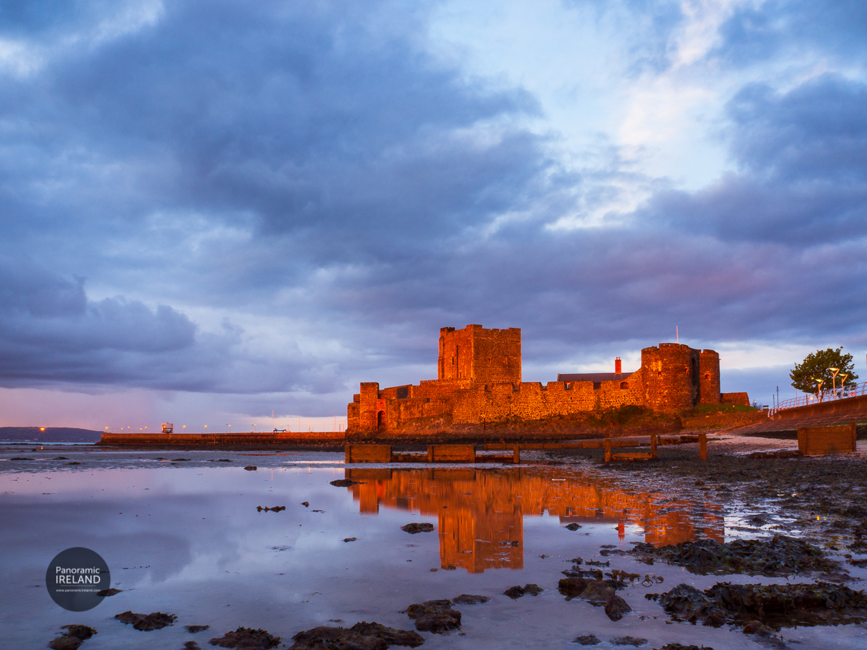 Carrickfergus Castle Glow Carrickfergus Castle aglow in sunlight under a cloudy sky