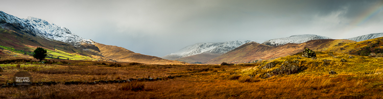 West of Ireland panorama with mountains, valley and a rainbow