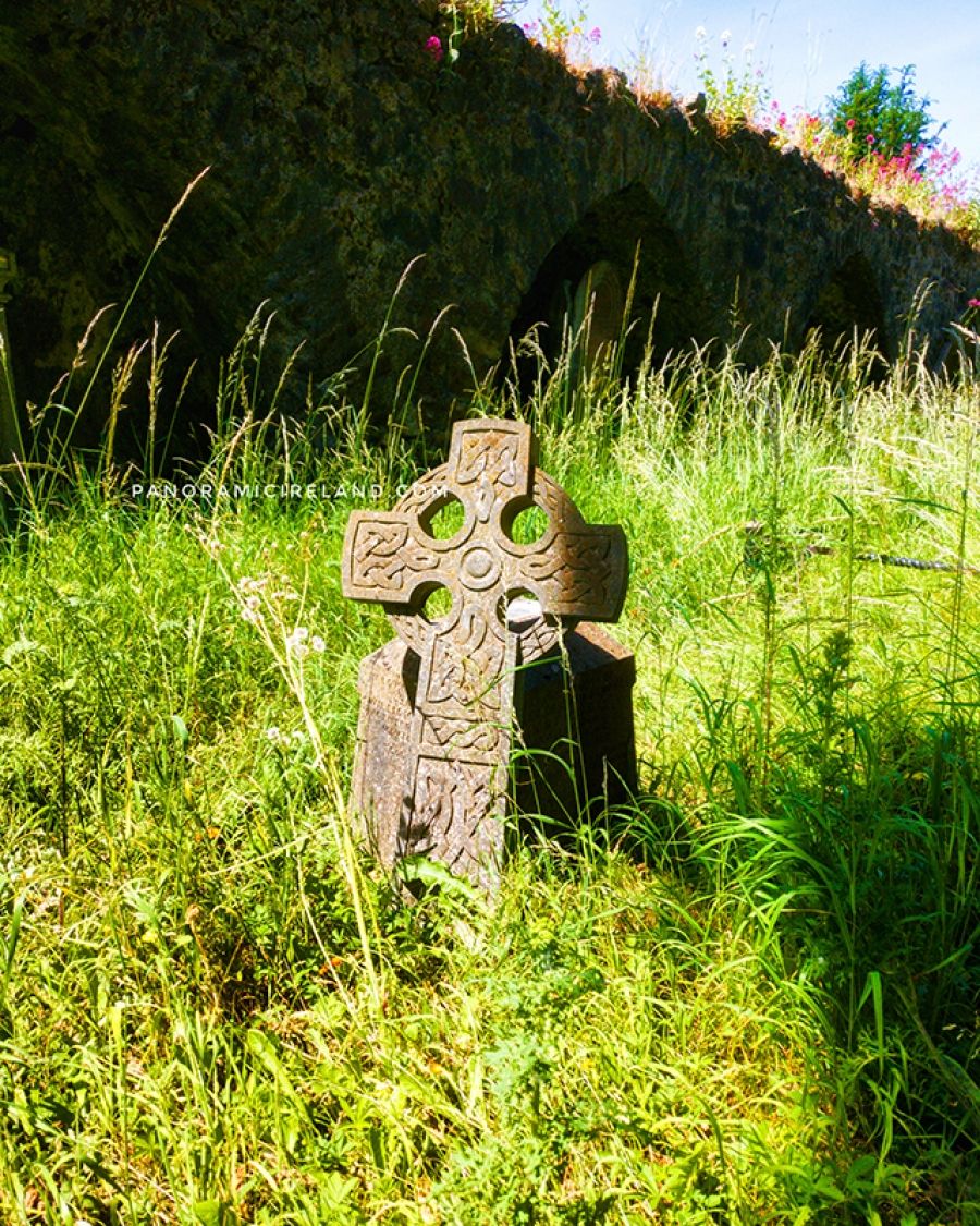Graveyard, old cross gravestone in grass